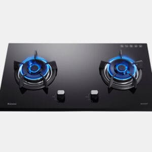 Two-burner black glass gas cooktop with blue flames lit and two central control knobs, modern kitchen appliance.