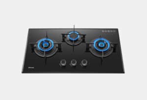 Black glass gas cooktop with three lit burners and blue flames; three silver control knobs centered below. A Rinnai logo is visible on the left edge.