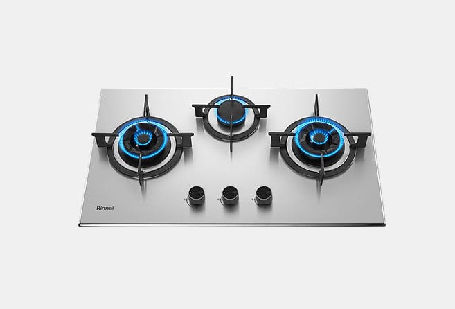 Stainless steel three-burner gas cooktop with blue-flame burners and three control knobs on the front.