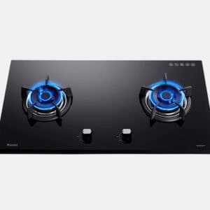 Black glass two-burner gas cooktop with blue flames on each burner and centered control knobs.
