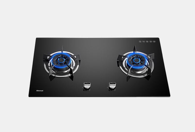 Black glass gas cooktop with two lit burners and front-facing control knobs on a sleek surface.