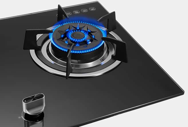 Black glass gas cooktop with three lit burners and blue flames; control knobs centered below the burners.