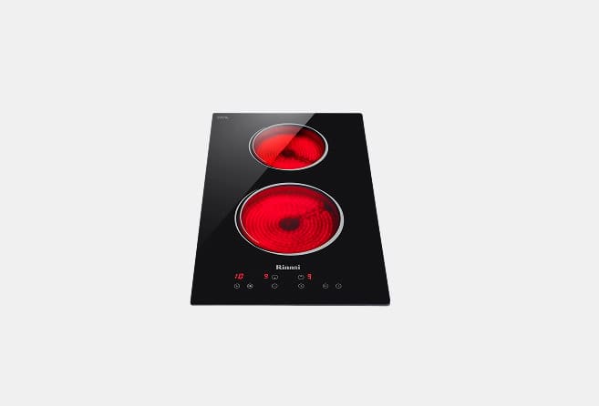 Black glass electric cooktop with two red induction burners and touch controls along the bottom