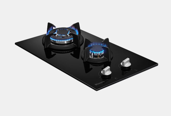 Sleek black glass gas cooktop with two lit burners and chrome control knobs on the right.