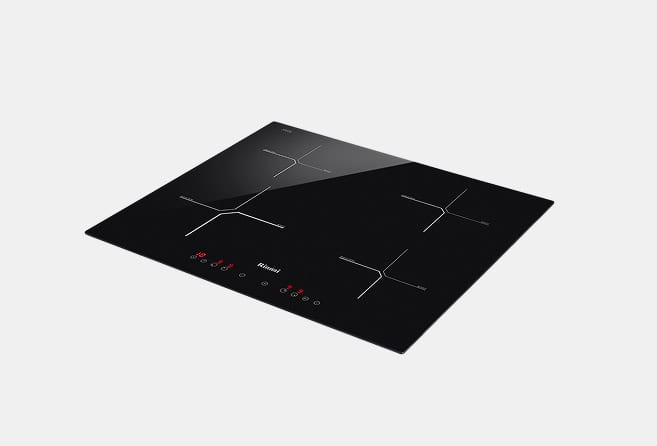 Black glass-ceramic induction cooktop with four cooking zones and red touch controls seen from an angled top view