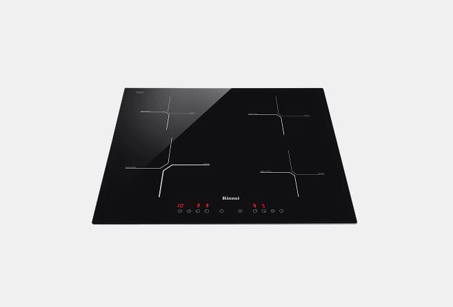 Induction cooktop with four cooking zones on a black glass surface and red digital controls at the front panel.