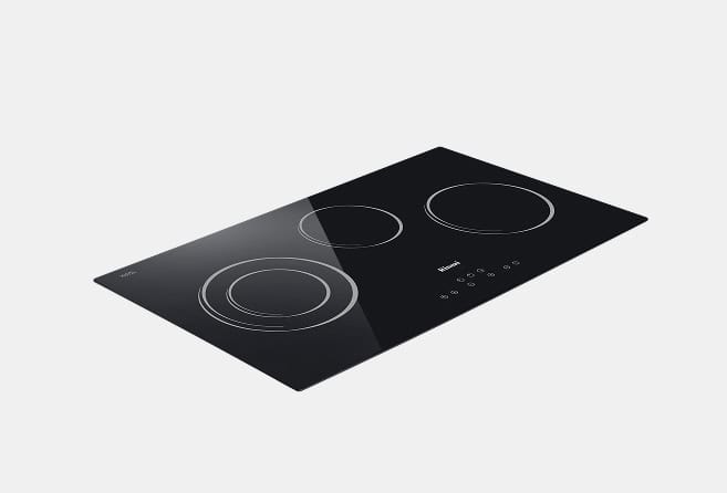 Black glass induction cooktop with three circular cooking zones and touch controls, angled view.