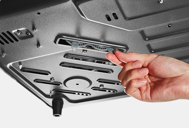 Person inserting a computer component into a motherboard slot inside a device, demonstrating internal hardware installation.