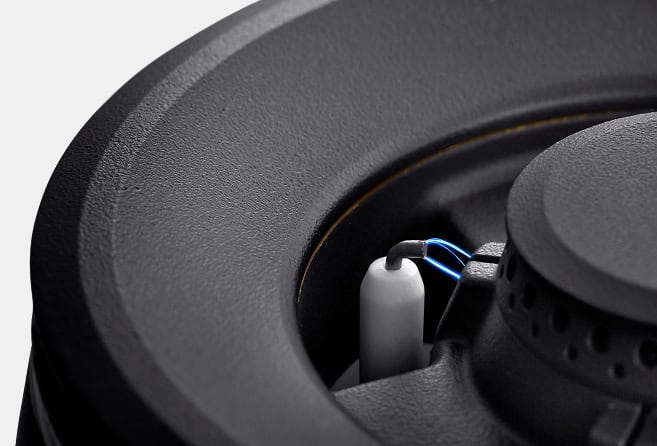 Close-up of a loudspeaker internals showing the voice coil and wiring.