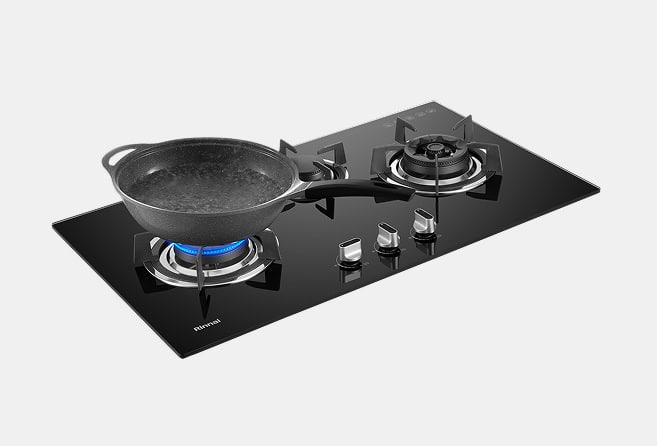 Black glass gas cooktop with two burners; a gray pot boils on the left burner.