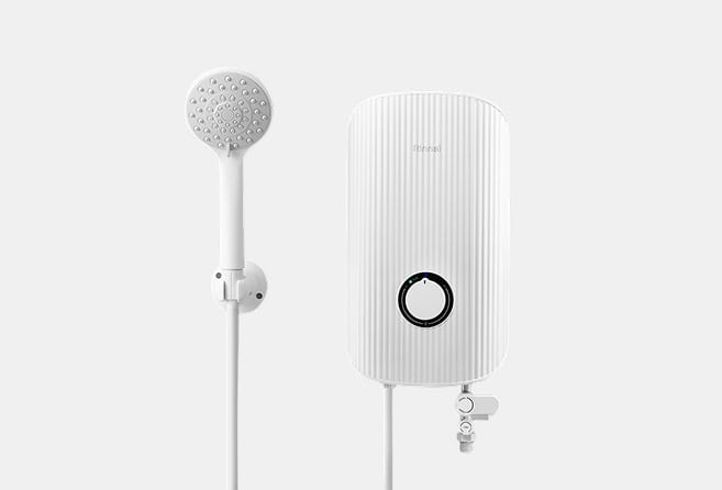 White wall-mounted electric shower heater with a ribbed oval body and a circular control, paired with a handheld showerhead on the left