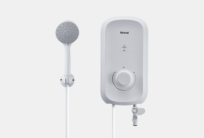 White wall-mounted shower water heater with a circular control dial and a handheld showerhead on a hose.