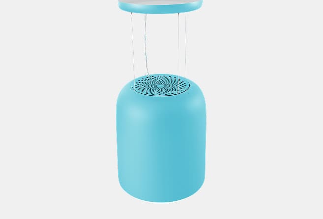 Blue cylindrical tabletop water dispenser with a vented round top seen from above, set against a light background