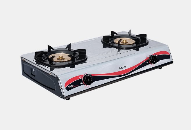 Two-burner portable gas stove with a shiny metal body, black control knobs on the front, and brass burner heads with a red and black decorative stripe along the side edge, set against a light background.