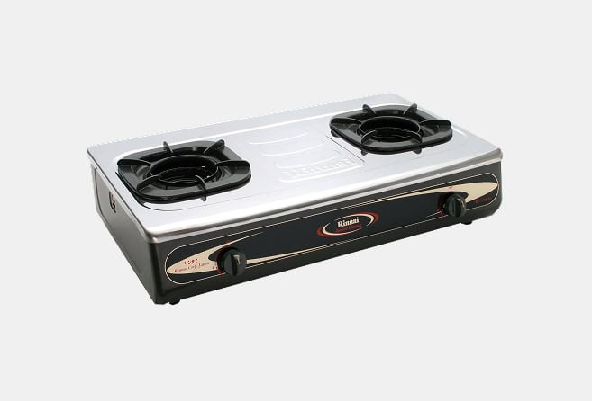 Two-burner portable gas stove with black burners and a silver top on a dark base.