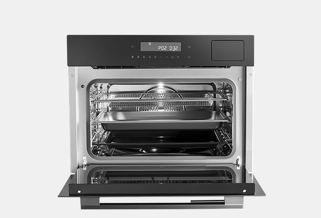 Open stainless-steel oven with interior light on, showing two wire racks and a baking pan inside.