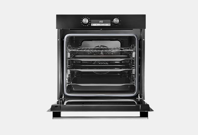 Open black oven showing multiple chrome racks and a visible fan at the back, ready for baking.