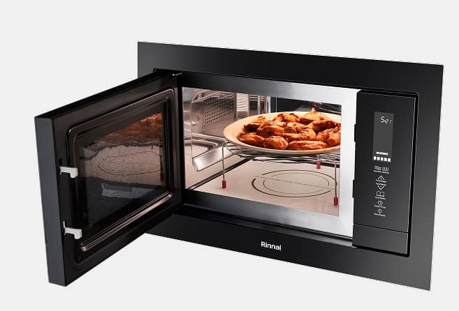 Built-in black microwave oven with the door open, revealing a plate of pastries inside.