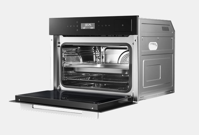 Compact stainless steel convection oven with door open, showing racks and metal baking tray inside.