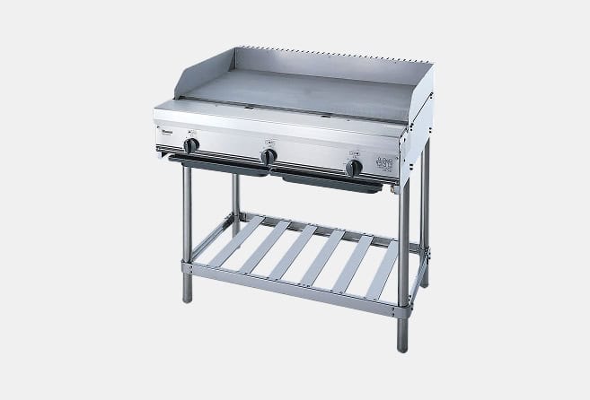 Stainless steel three-burner gas grill with a raised lid and a lower slatted shelf on metal legs