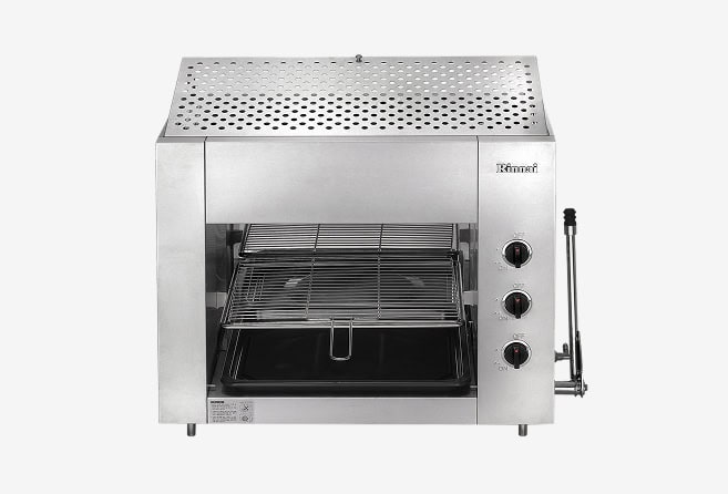Stainless steel countertop toaster oven with perforated top vent and interior rack, plus a side rotisserie crank for turning food.