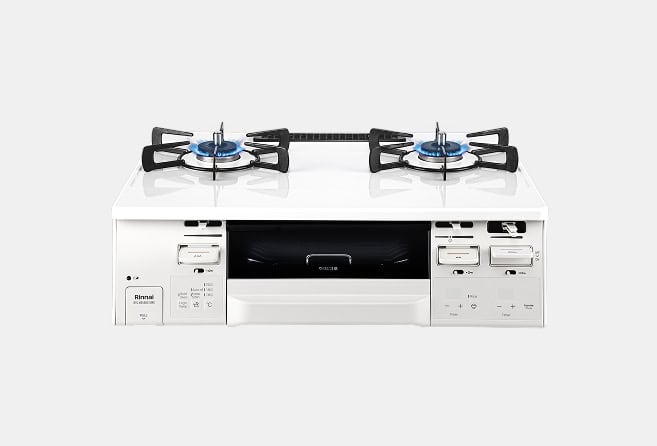 White gas range with two burners on a glossy white cooktop and a small oven drawer in the middle; side control panels visible.