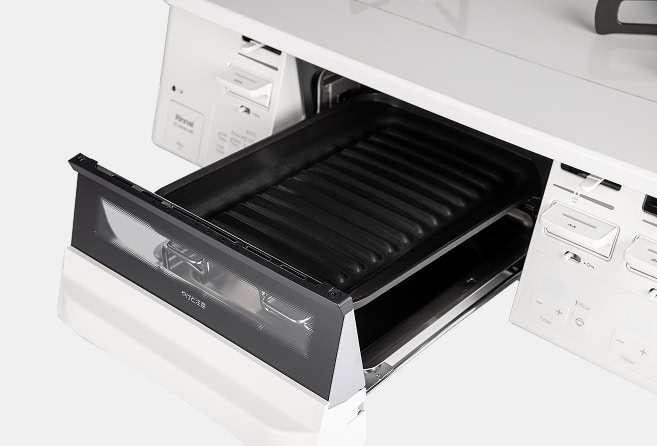 White gas range with two burners on a glossy white cooktop and a small oven drawer in the middle; side control panels visible.