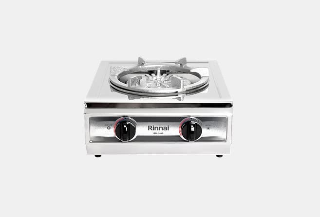 Stainless steel single-burner gas stove with two control knobs on a front panel (Rinnai branding).