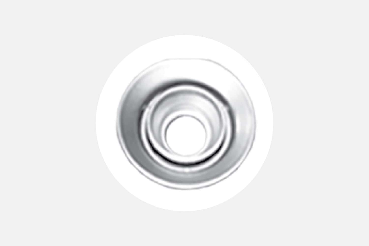 Close-up of a shiny silver circular metal dial with concentric rings